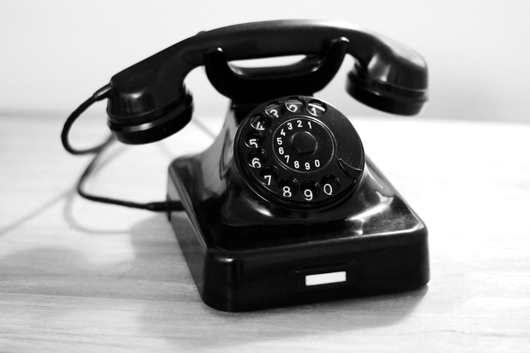Photo by Katrin Hauf black rotary phone on white table